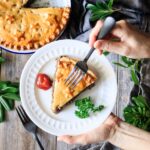 holding a slice of French Canadian meat pie with a fork