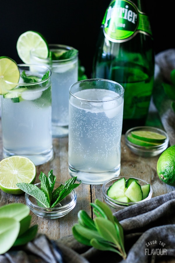 three glasses with bowls of mint and cucumber