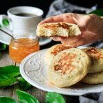 person holding an English crumpet