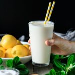 person holding a glass of frozen lemonade