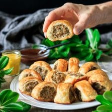 person holding a sausage roll