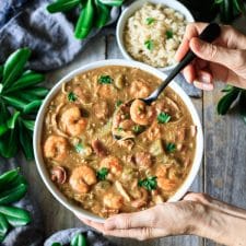 holding a bowl of gumbo