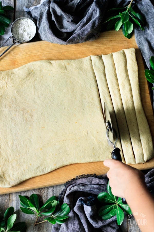 cutting strips of dough for Swedish cardamom buns