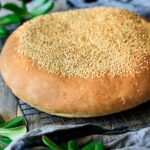 loaf of muffaletta bread on a cooling rack