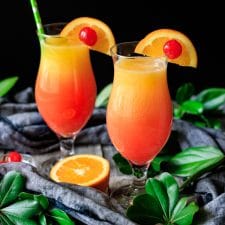 two sweet sunrise drinks with half an orange