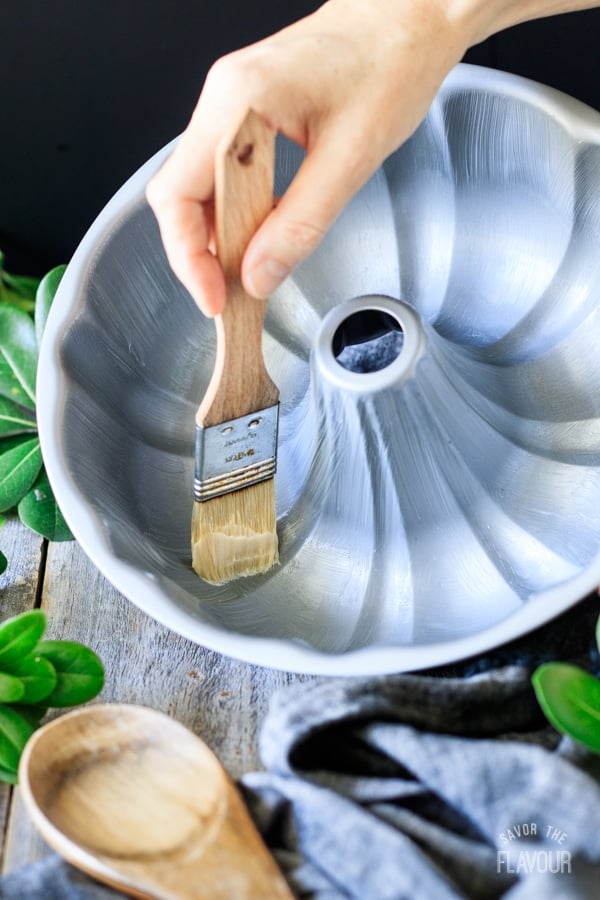 greasing the pan for maple walnut bundt cake