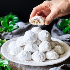 holding one of the Mexican wedding cookies