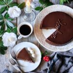 slice of sachertorte on a plate with forks