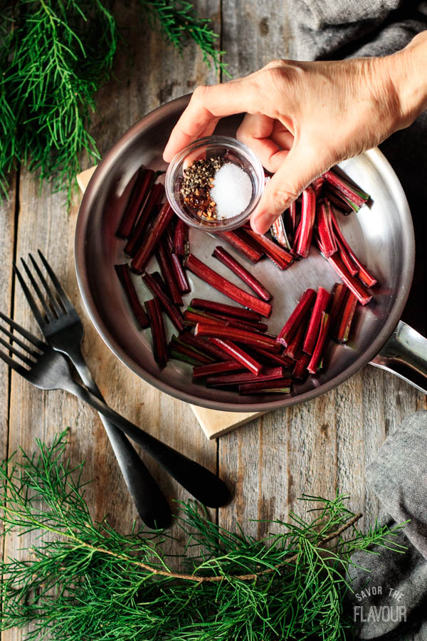 adding salt and pepper to stems for beet greens