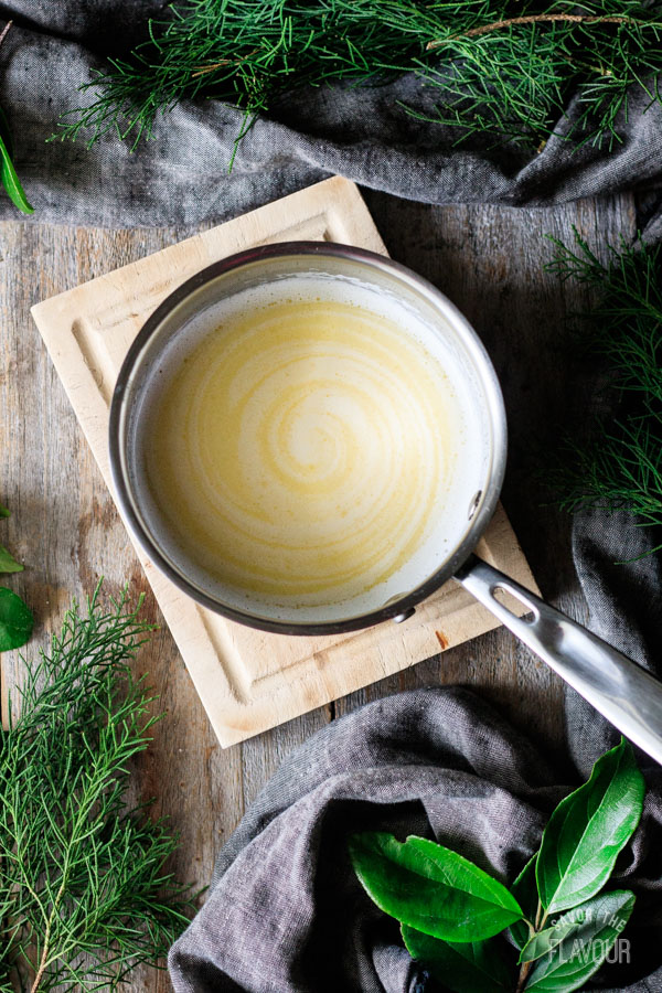 melted butter, lard, and milk mixture in a pot for Hawaiian sweet rolls