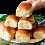 holding one of the Hawaiian sweet rolls