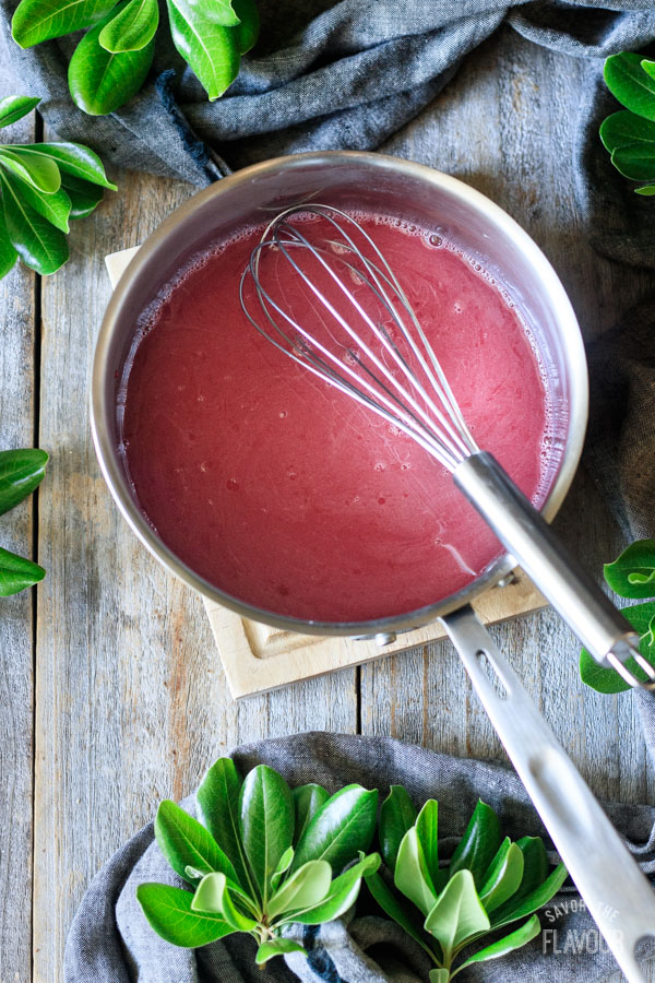 whisking cornstarch mixture in a saucepan