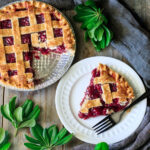 slice of cherry pie on a plate with a fork