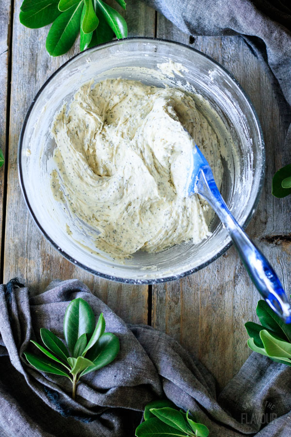 mixing lemon poppy seed cake batter with a spatula