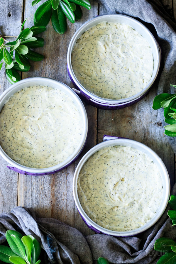 three cake pans filled with cake batter