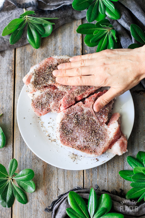 rubbing spices into pork chops