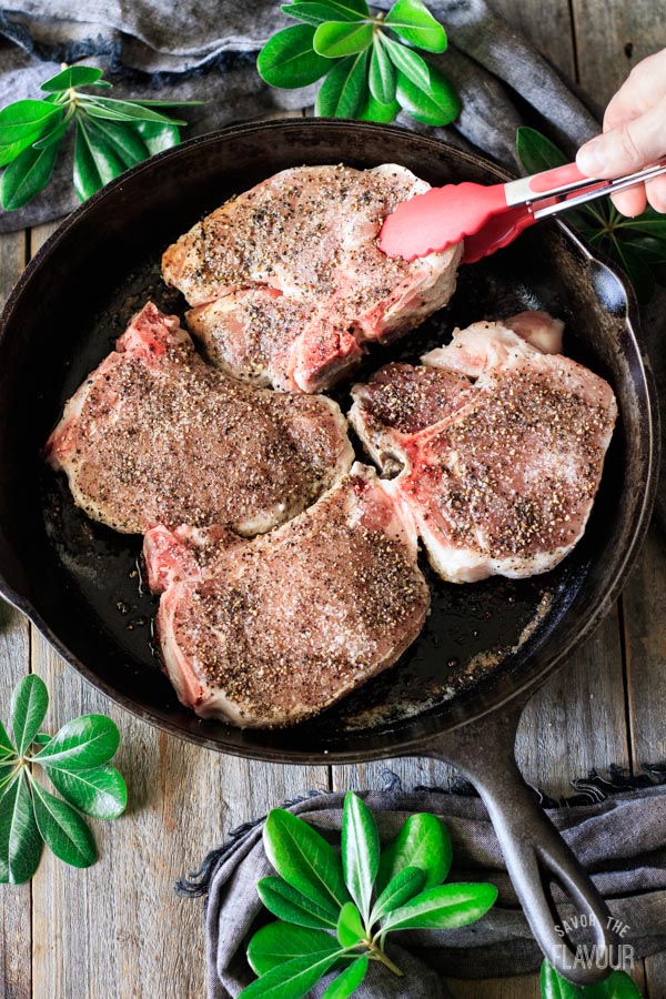 flipping pork chops with tongs