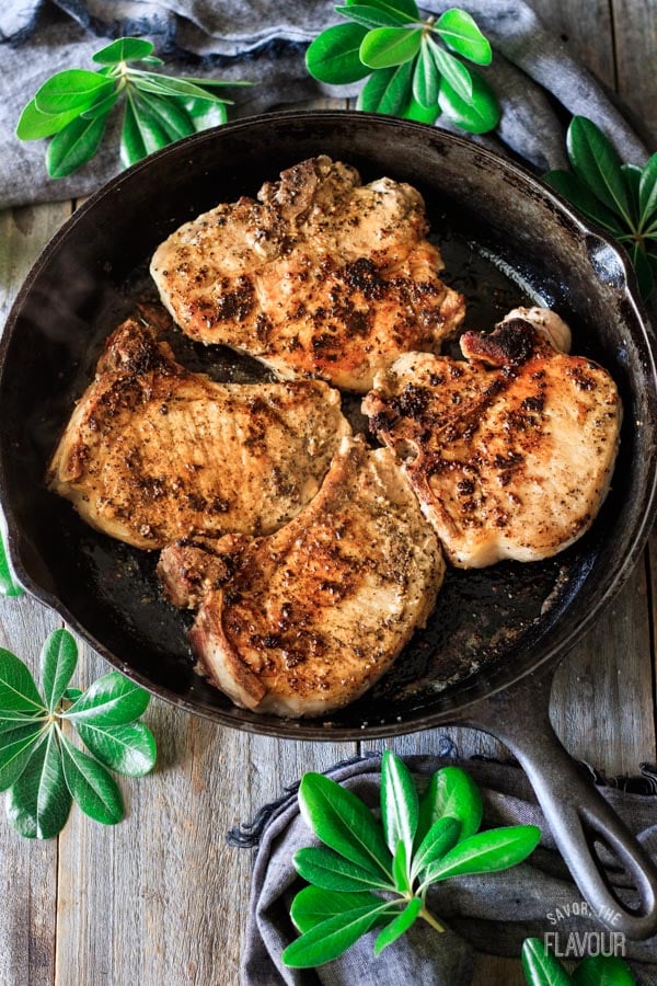 searing pork chops in a cast iron skillet