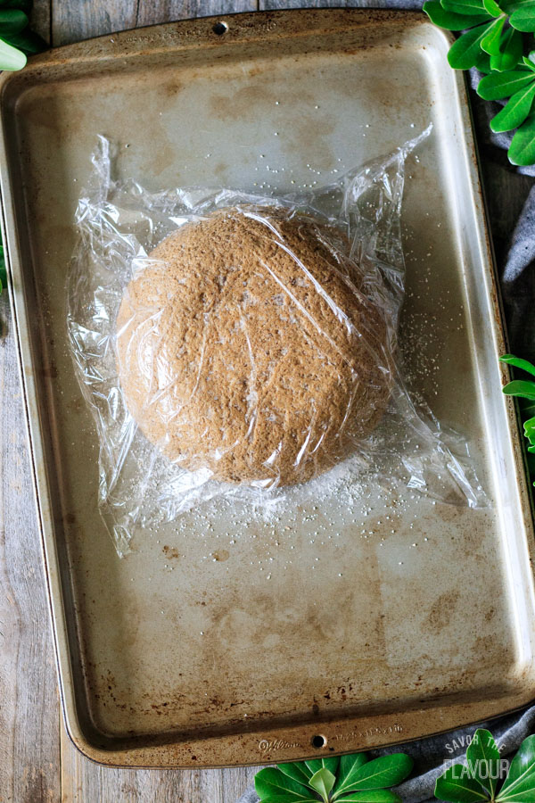 loaf of pumpernickel bread on a cookie sheet