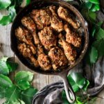 smothered chicken in a cast iron skillet