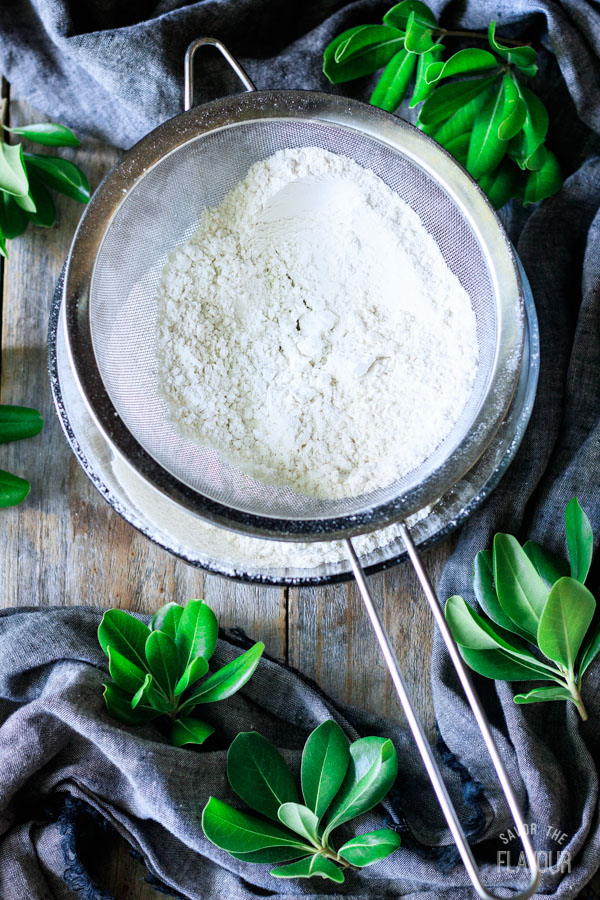 sifting flour and baking soda into a bowl