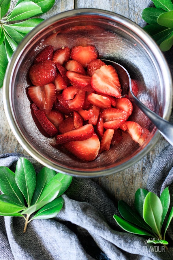 macerating strawberries in a bowl