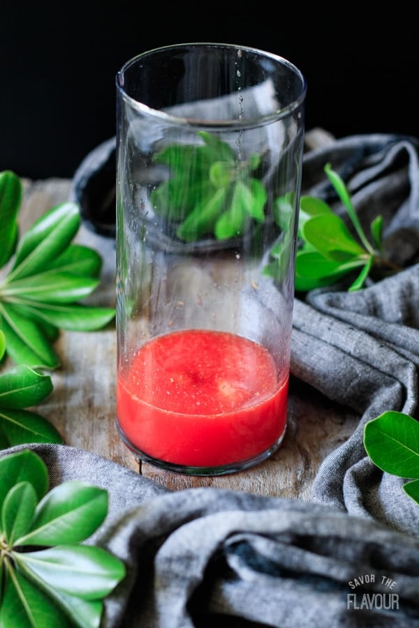 mixing strawberry citrus blush in a glass
