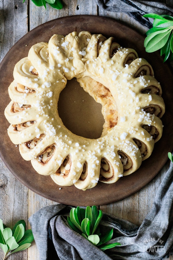sprinkling pearl sugar on top of a Swedish tea ring