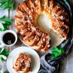 Swedish tea ring on a plate with a cup of tea