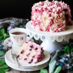 slice of lemon blueberry cake with a cup of tea and fork