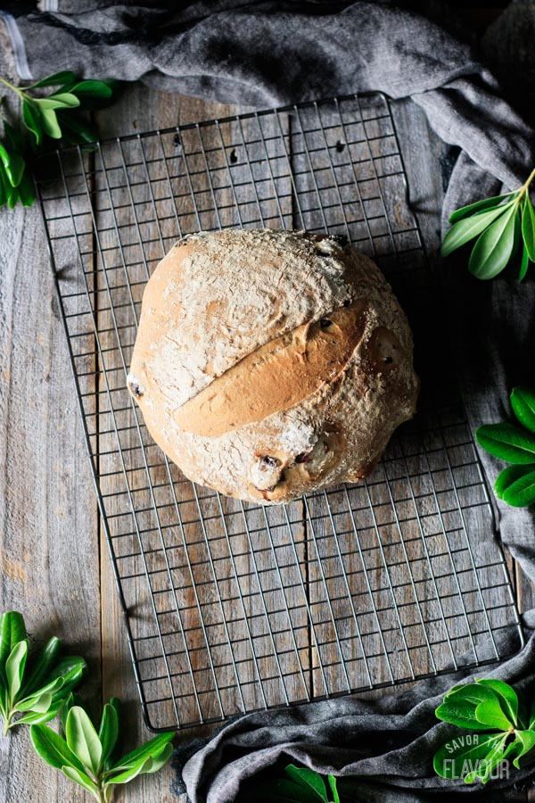 loaf of olive bread on a wire cooling rack