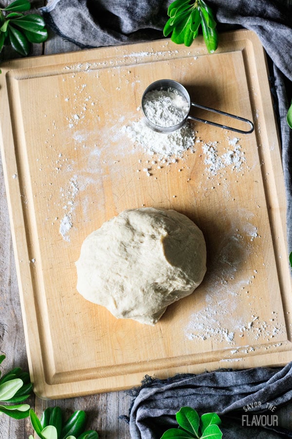 kneaded dough with flour on a cutting board