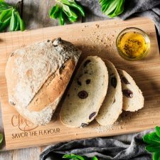loaf and slices of olive bread on a cutting board