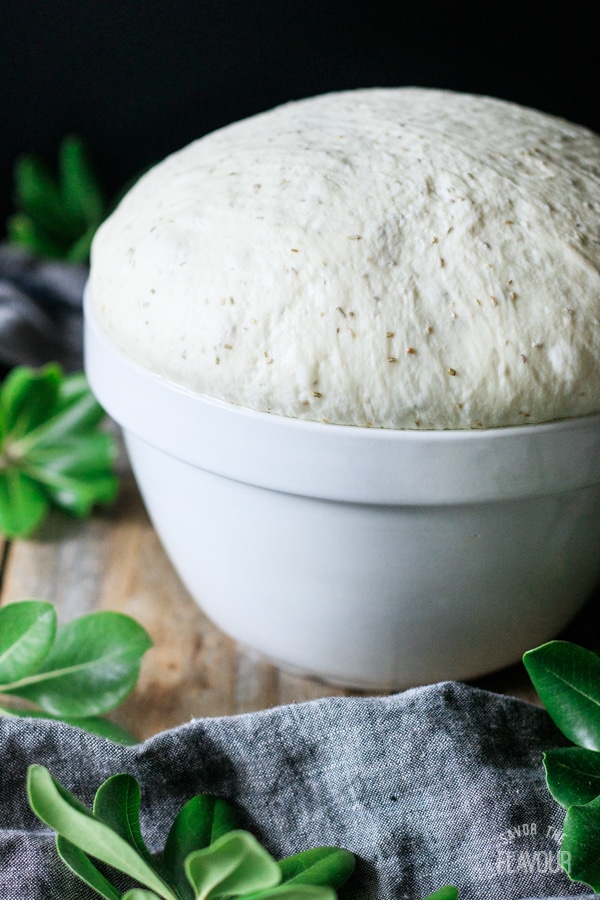 bowl of risen rosemary bread dough