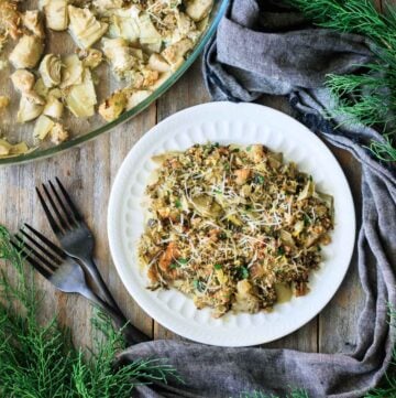 plate of artichoke casserole with two forks