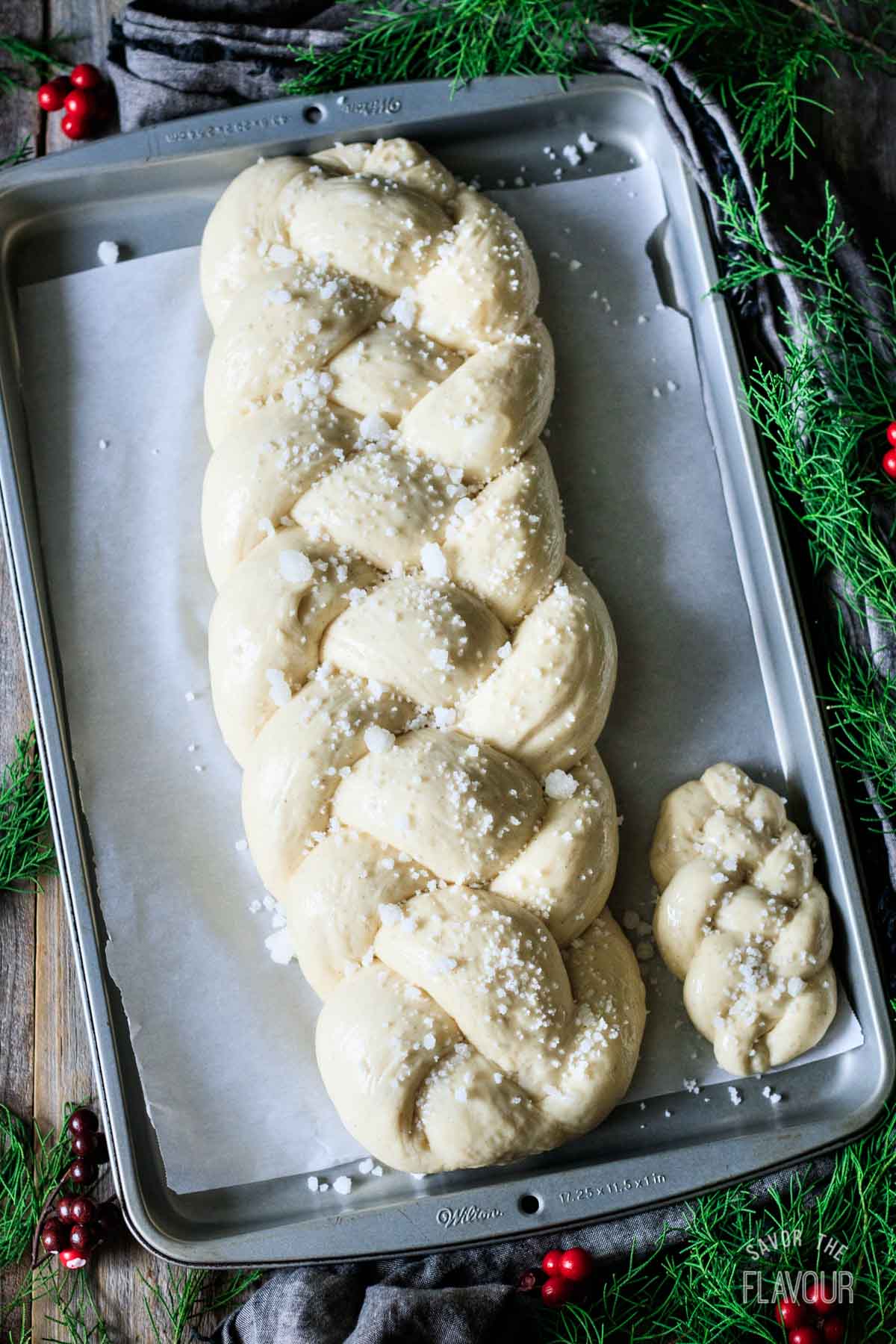 sprinkling pearl sugar on proved pulla bread