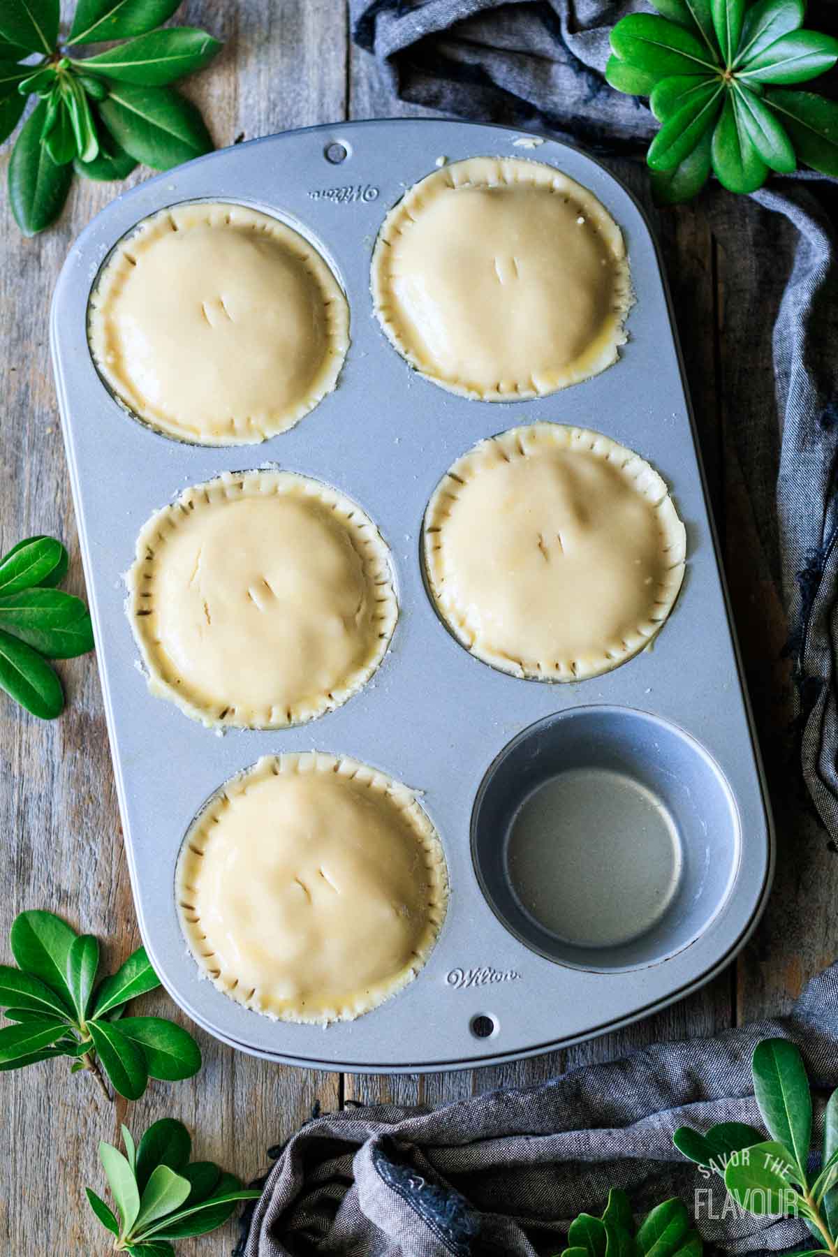 putting pastry tops on turkey cranberry pies