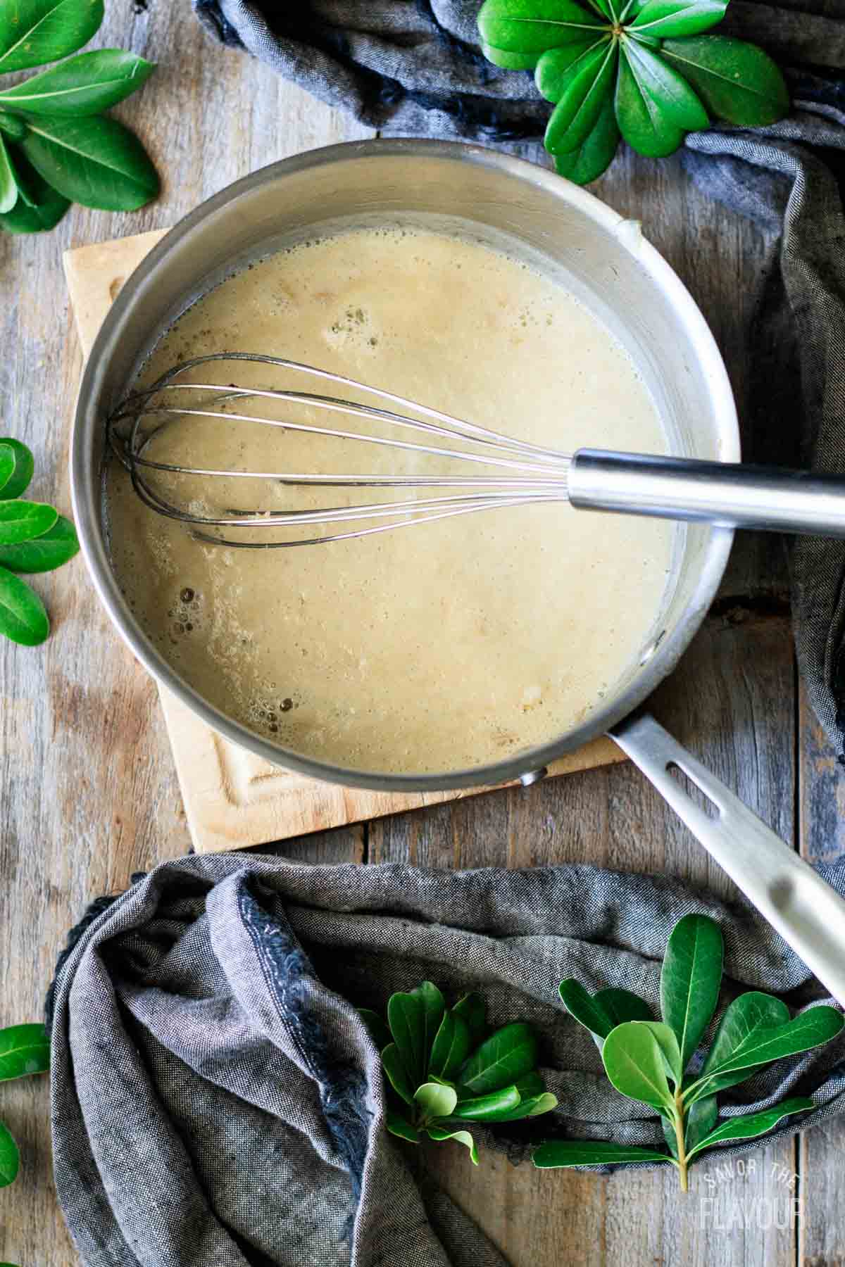whisking the roux in a saucepan