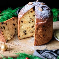 loaf of panettone on a bamboo cutting board