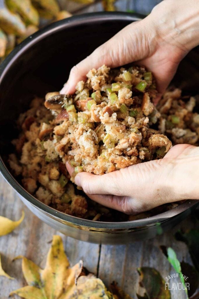mixing the turkey stuffing ingredients in a bowl