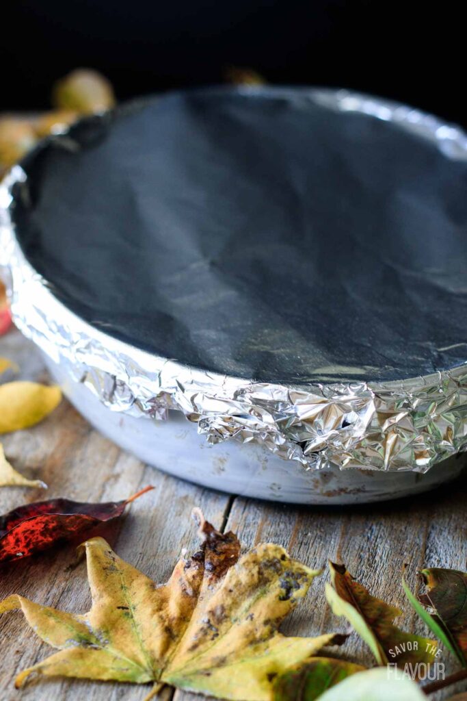 pan of turkey stuffing covered with aluminum foil