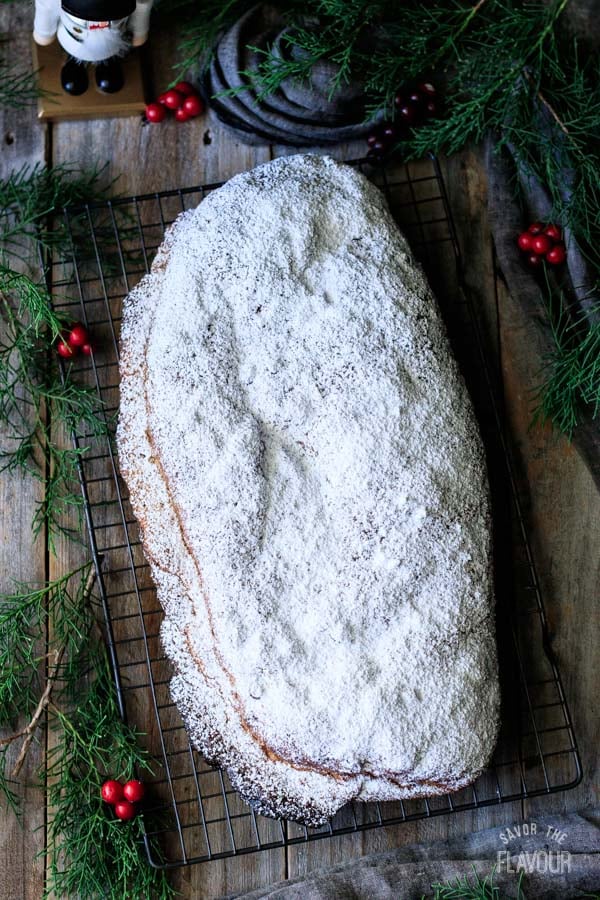 loaf of German stollen on a wire cooling rack