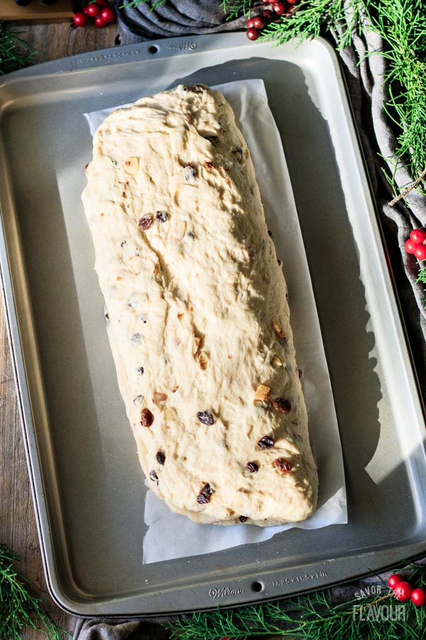 loaf of stollen on a cookie sheet before proving