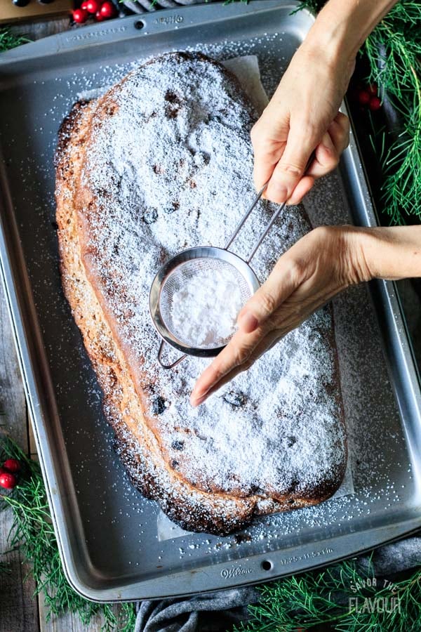 dusting the stollen with icing sugar
