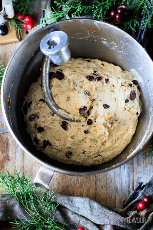 mixing the dried fruit into stollen dough with a mixer
