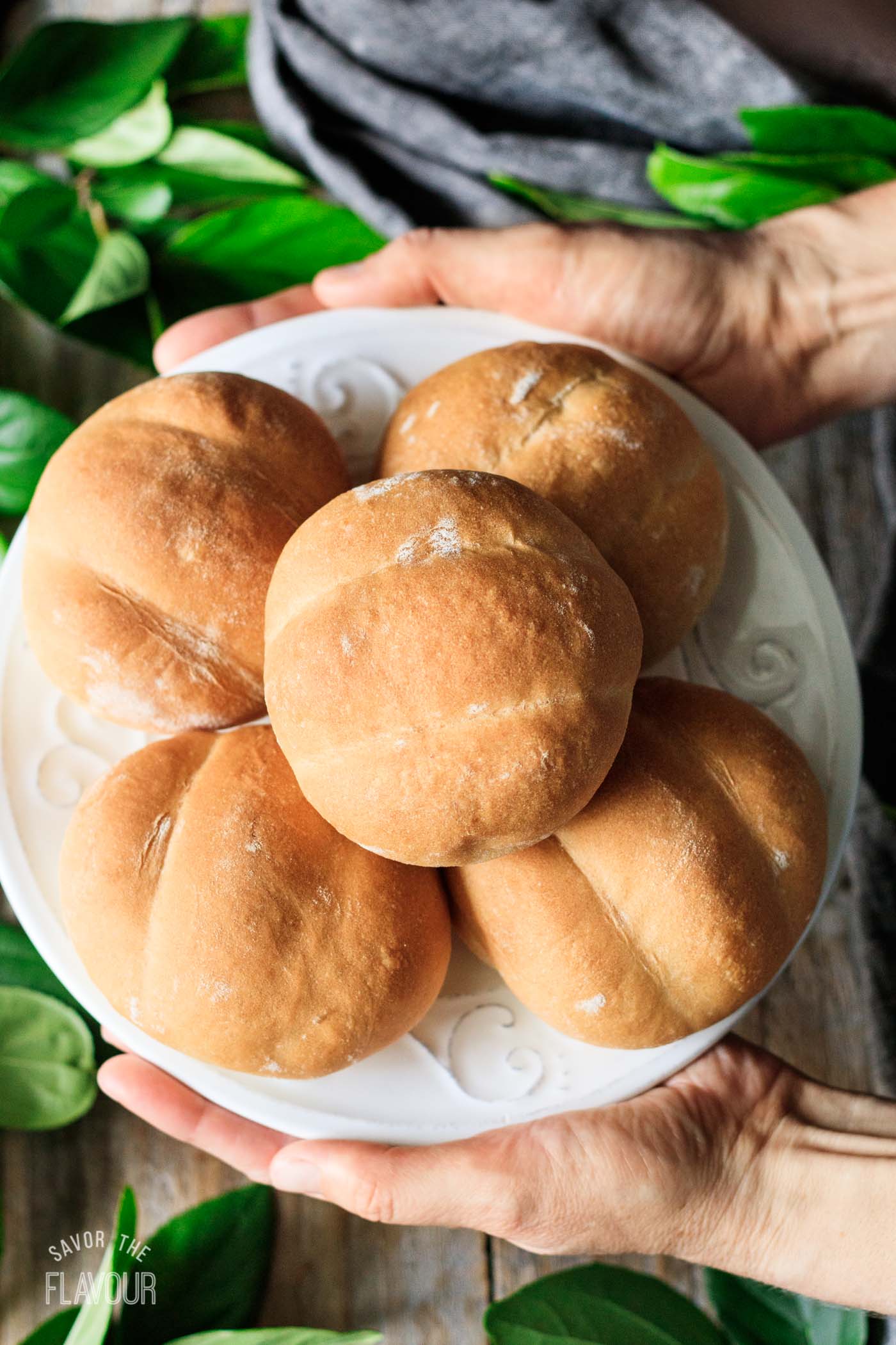 person holding a plate of teleras