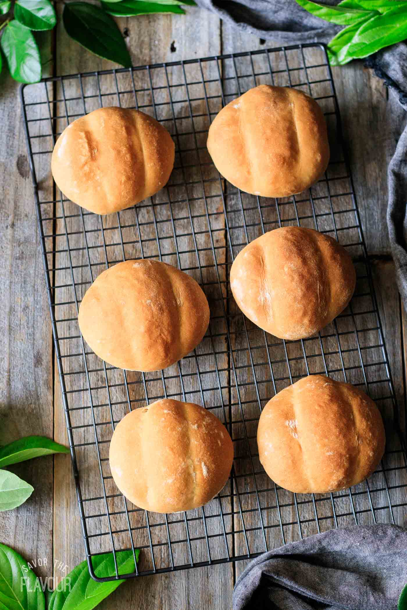 baked teleras on a wire rack