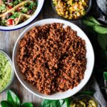 large bowl of walnut meat with tacos and toppings