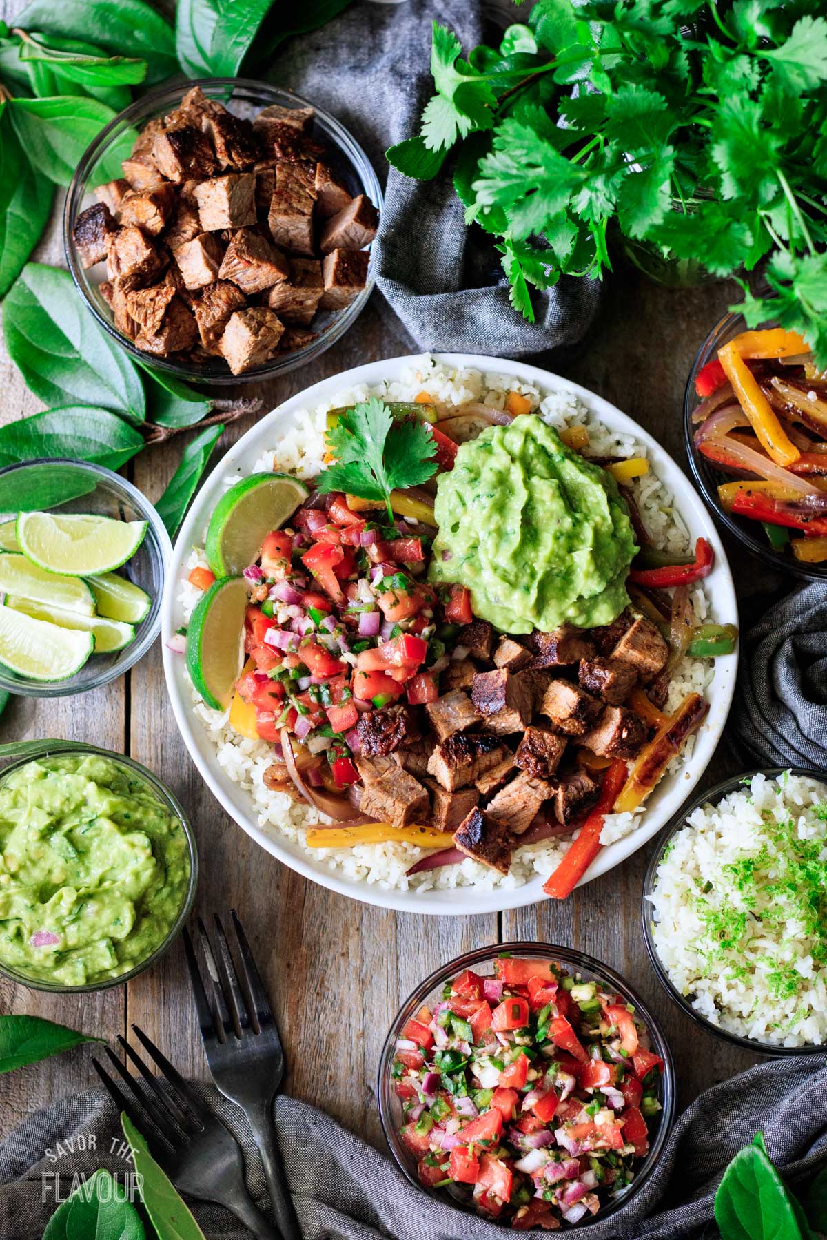 Chipotle steak in a bowl with rice, pico de gallo, and guac