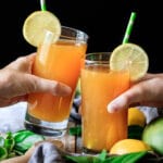 people doing a toast with two glasses of mango passion tea